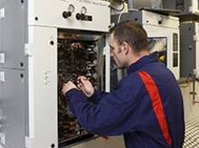 Technician maintaining  an industrial analysis system